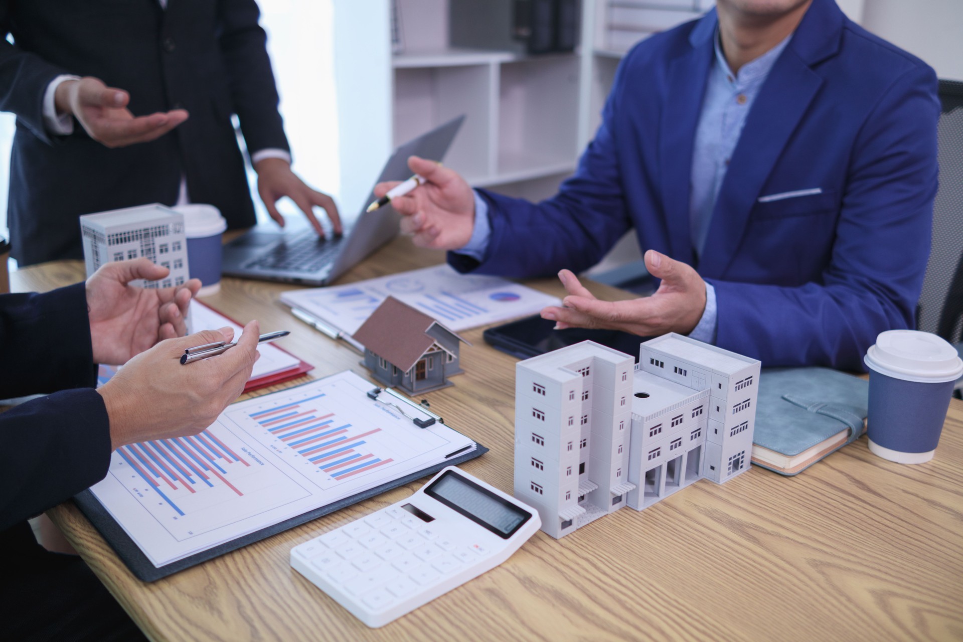 group of businessmen and investors discuss investing in real estate and jointly plan investments in construction projects of condominiums and apartments for sale and rent. investment advisory concept